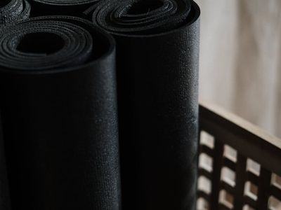 Close up of yoga mat and bamboo accessories.