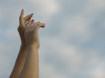 Hand reaching towards the sky in a peaceful motion.